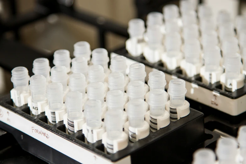 small pill bottles filled with empty pills on a tray