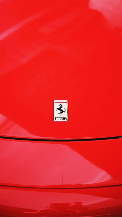 a ferrari badge on the hood of an exotic vehicle