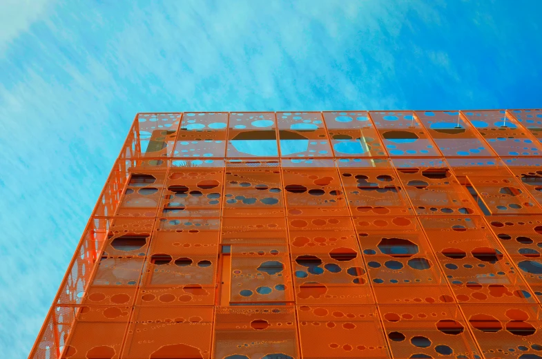 an orange building that is near some sky