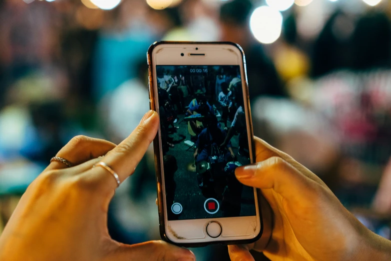 a person holding up an iphone in their hands