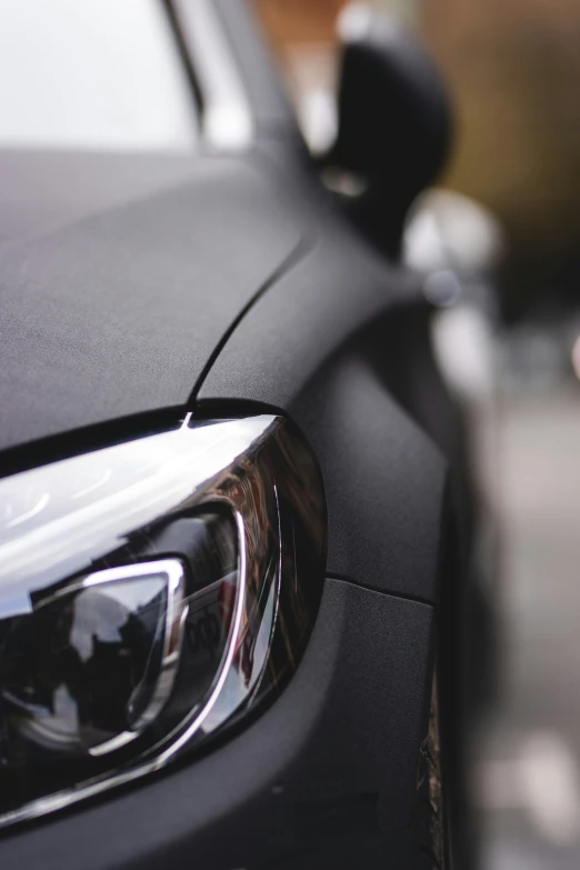 the lights on a black car near another car