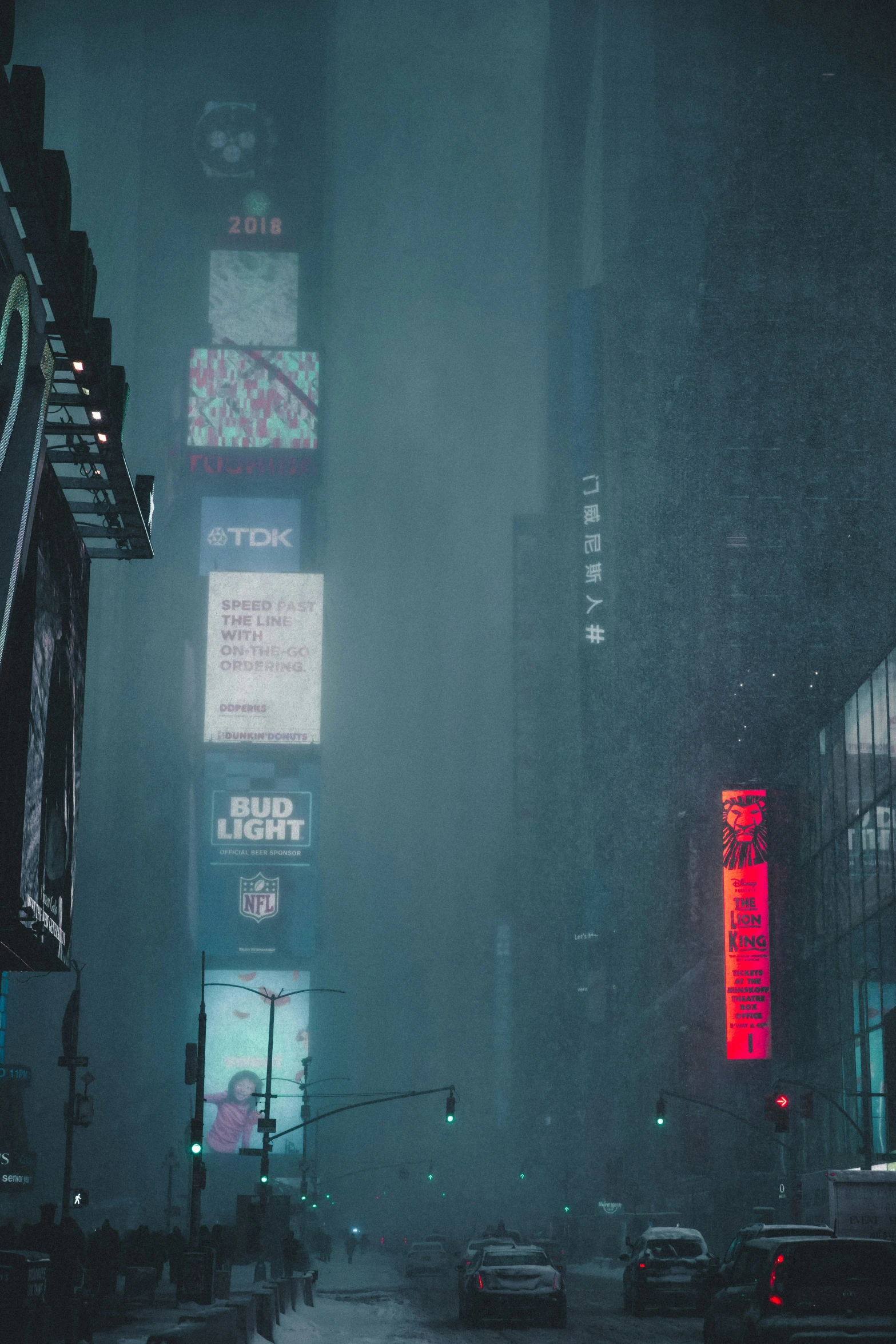 a city street filled with tall buildings covered in fog