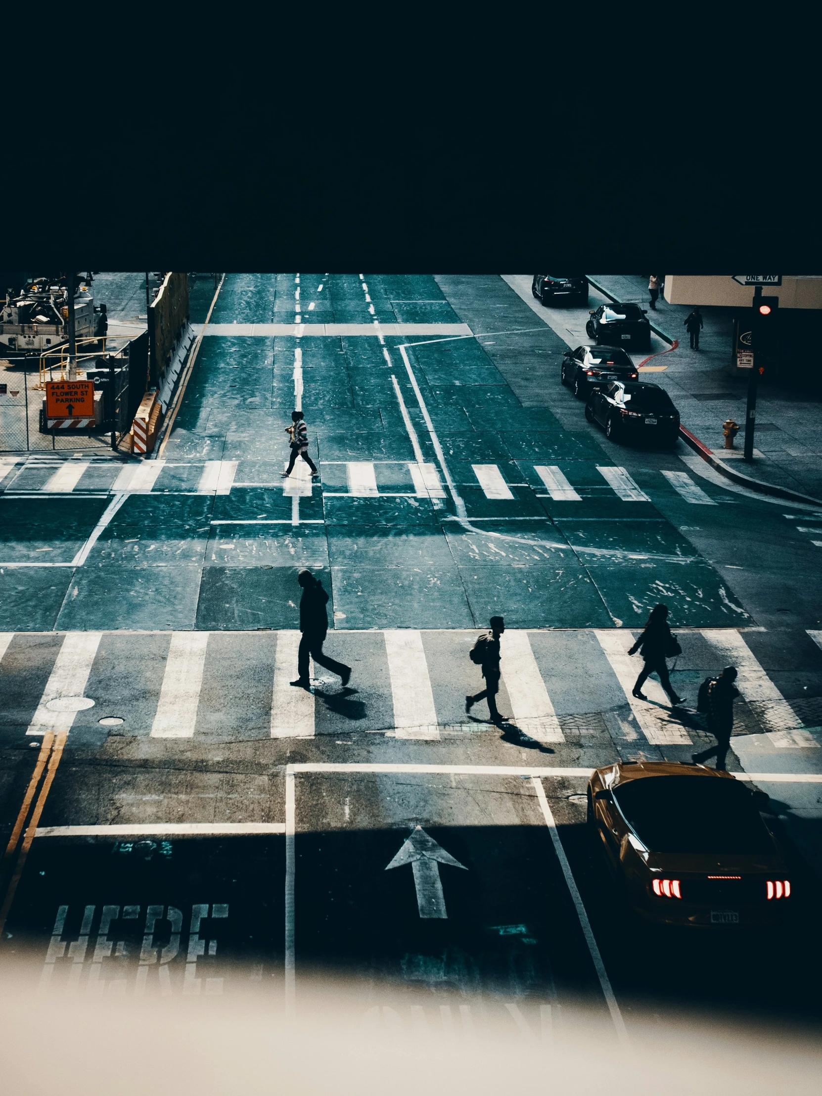 pedestrians crossing the street at night in the city