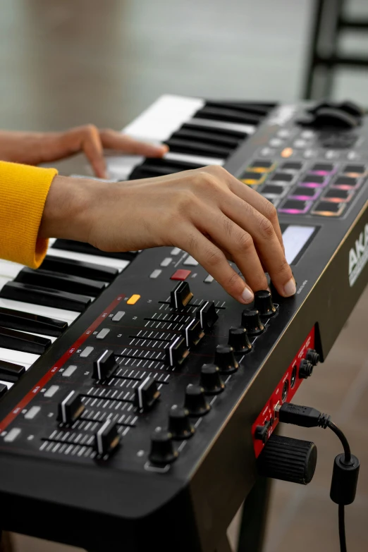 a person's hand is touching the keys on an electronic keyboard