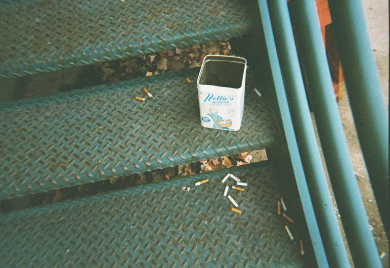 cigarettes and cigarettes box on the bottom of stairs