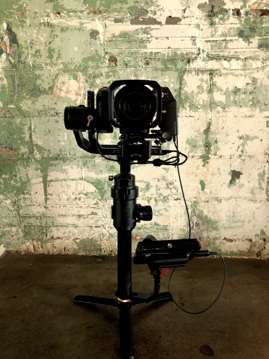 a small video camera is connected to an tripod