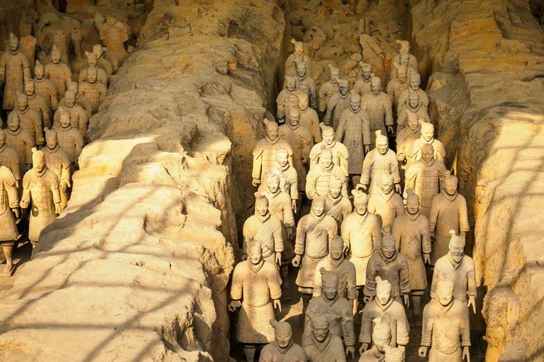 a crowd of statues are standing near each other