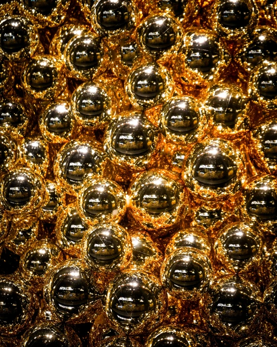 this wall is filled with shiny, metallic balls