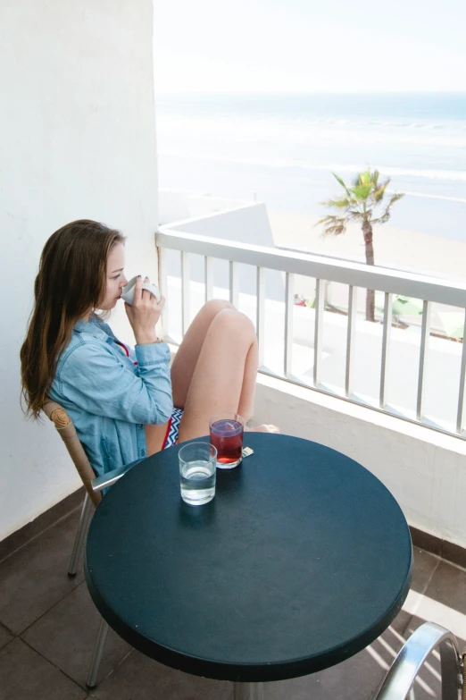 the woman drinks water out of her glasses