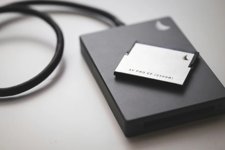a silver business card attached to a black box