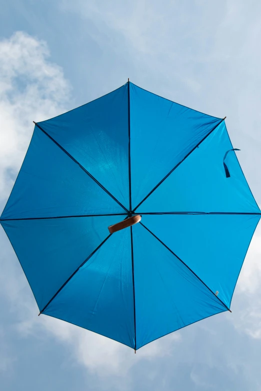 an open blue umbrella on a clear day