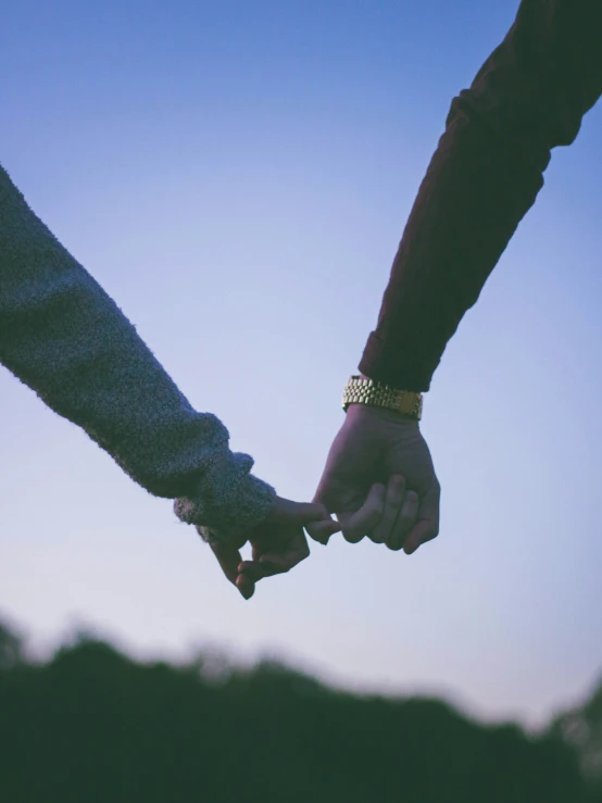 two people holding hands over their fingers