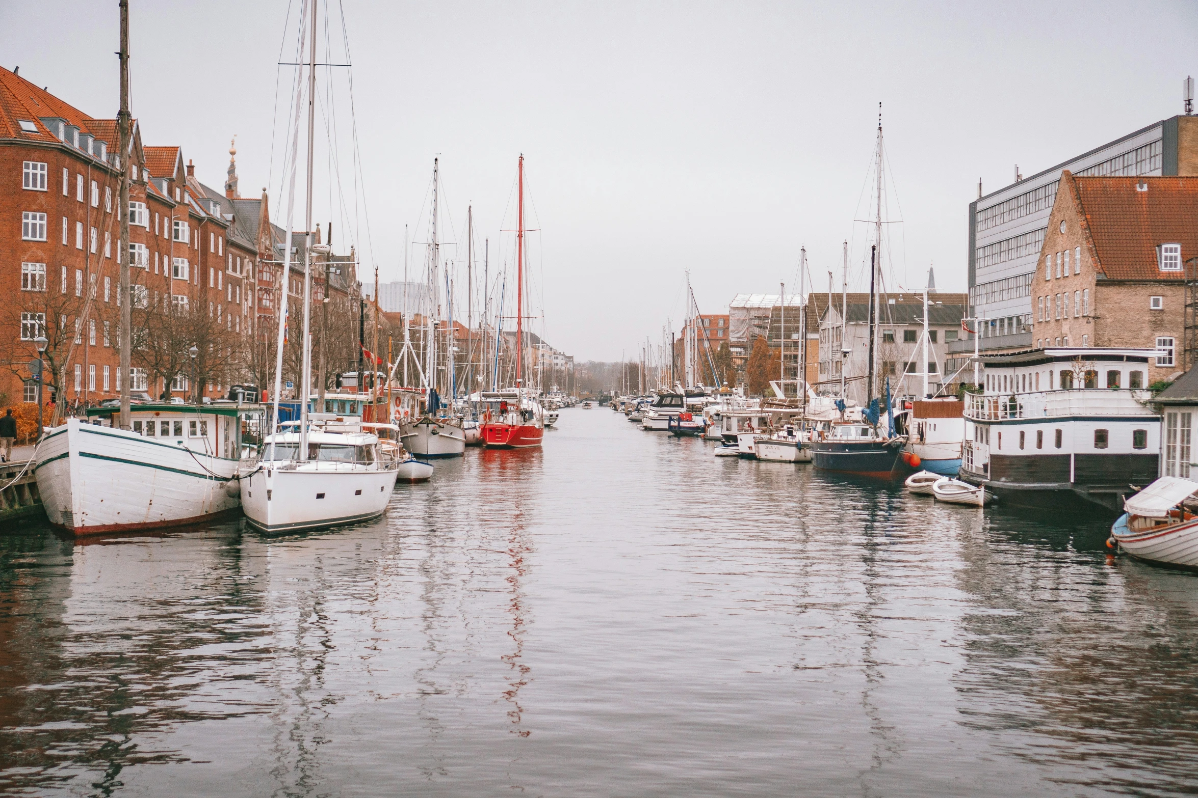 boats moored at a dock in an old city