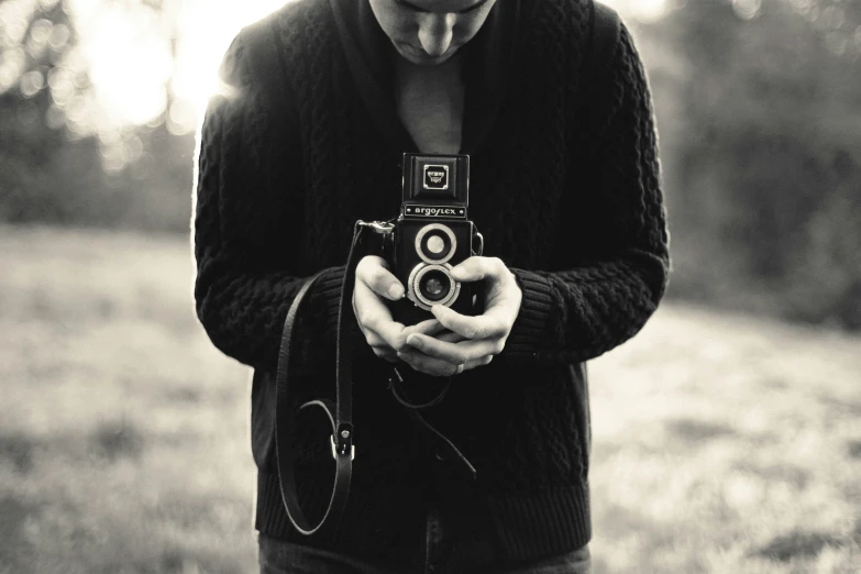 black and white pograph of man holding camera