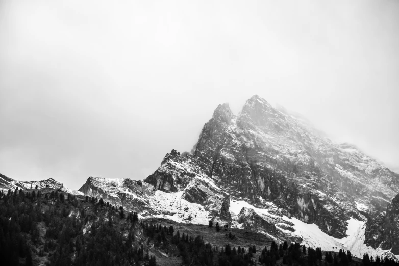 a black and white image of a snow - capped mountain