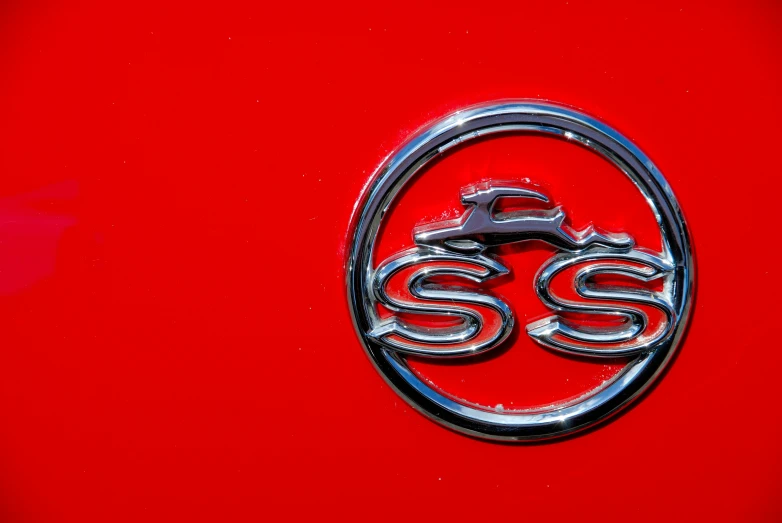 close up image of emblem on red and chrome vehicle