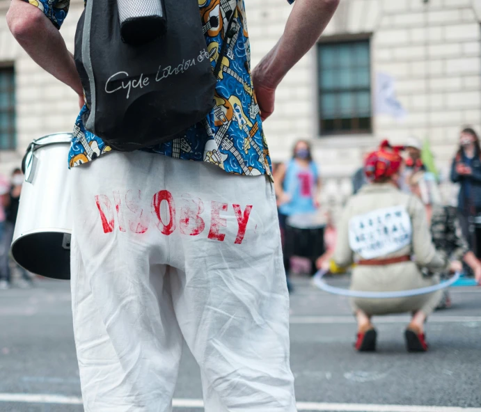 man in the middle of a protest and holding a bag