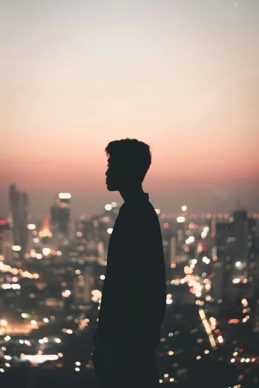 silhouette of a man with the city lights at night