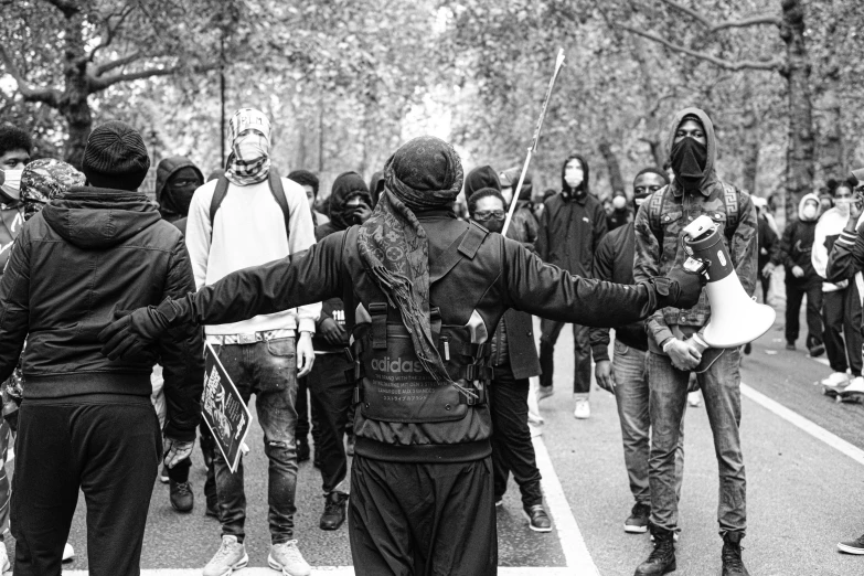 people walking and carrying protest signs in the street