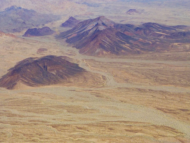 a group of mountains sit in a desert landscape