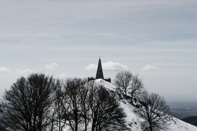 a steeple in the distance and some trees in the foreground