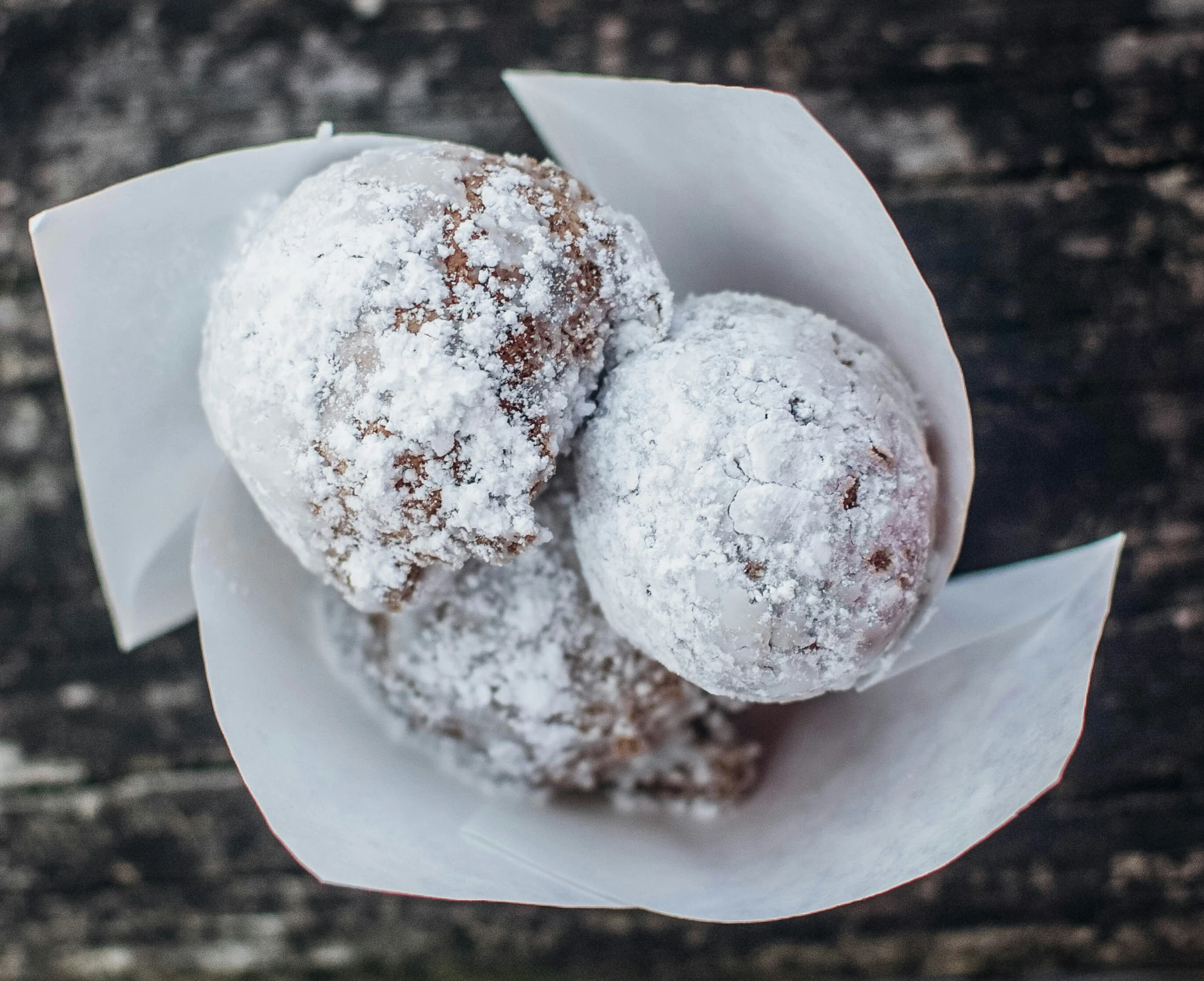 three different dessert items covered in powdered sugar