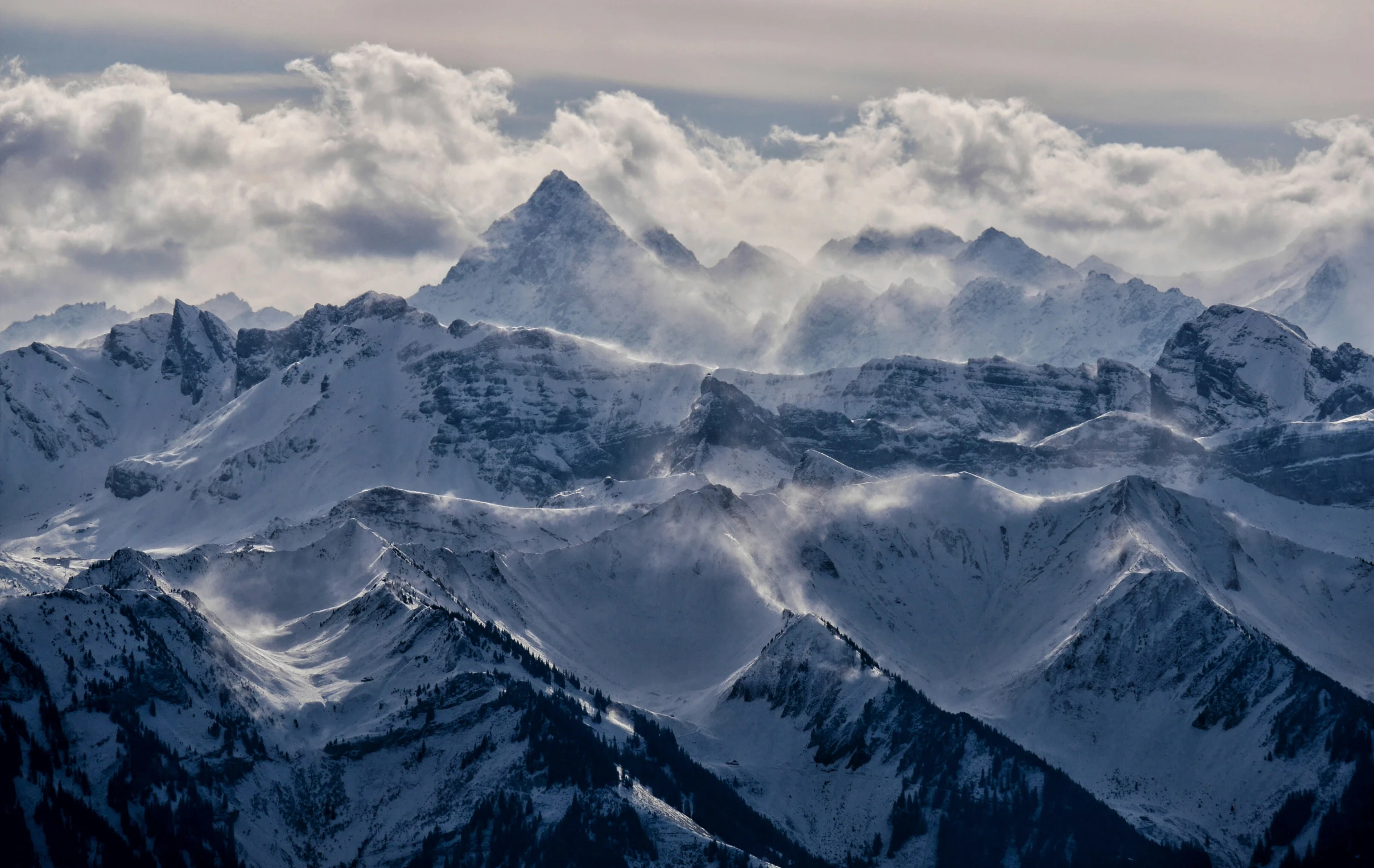 a view from the top of a snowy mountain