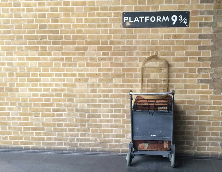 an image of a luggage cart that is sitting in front of the platform 9 sign