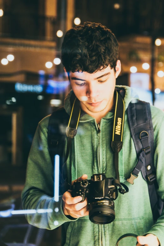 a young man looking at his camera