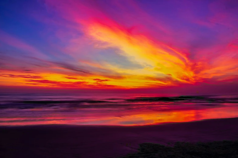 a beautiful sunset on the beach is reflected in water