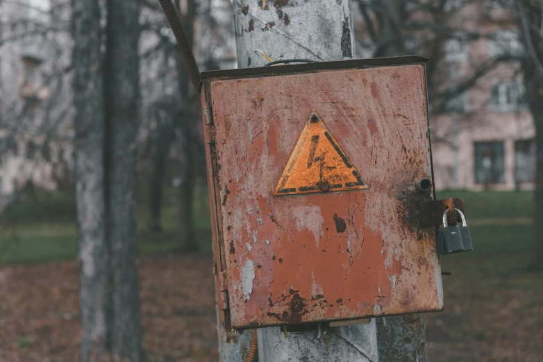 a rusted sign that is on a tree