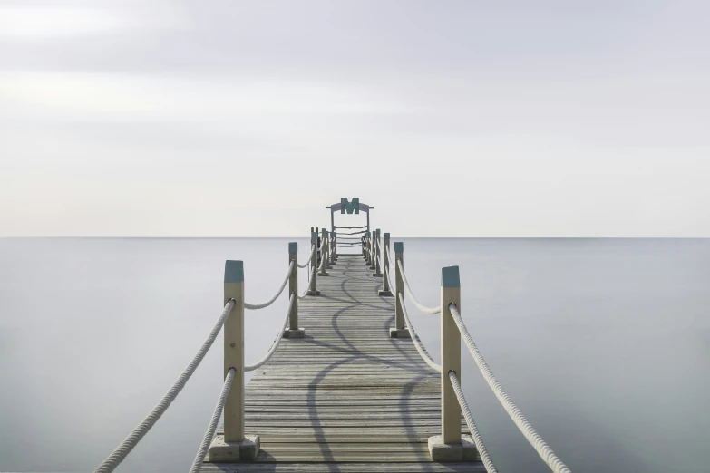 a boat dock sits on a calm sea
