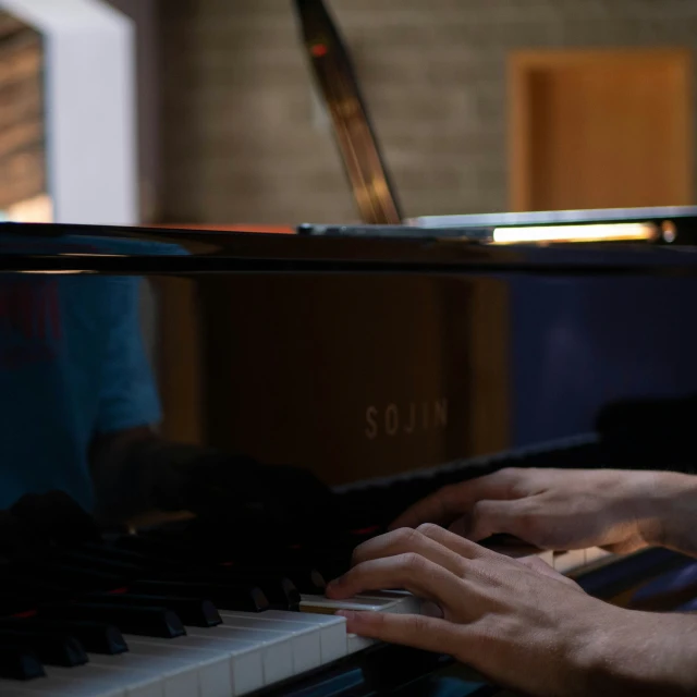 a person plays an electric piano in the dark