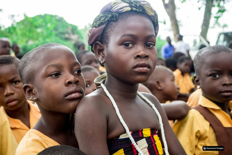 a group of children sitting in front of each other