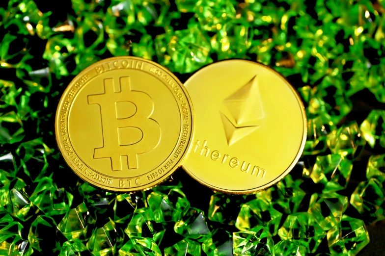 a golden bit coin sitting in the green grass