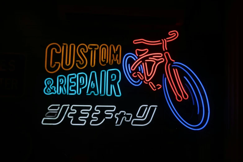 a neon sign for a bike shop and repair shop