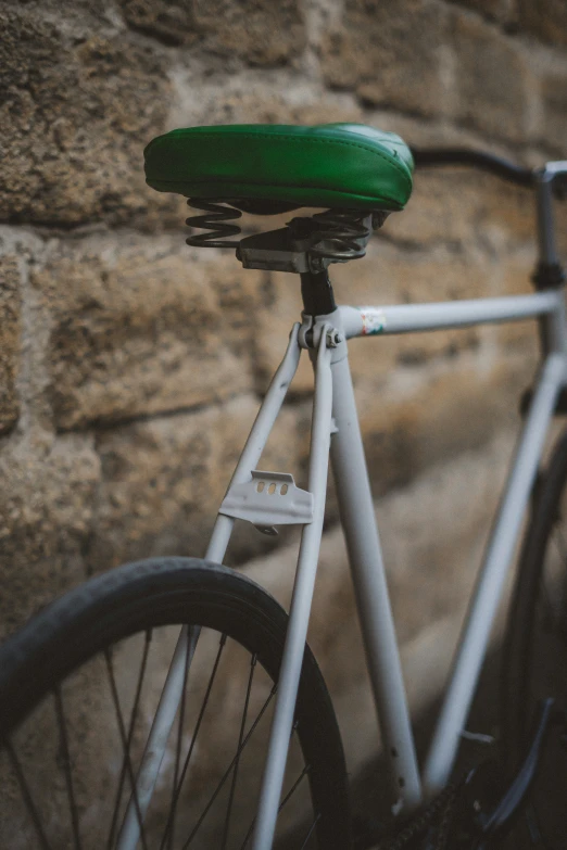 there is a green seat on the back of a bicycle