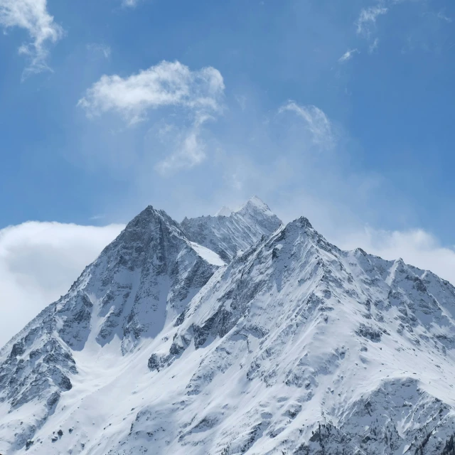 snow covered mountain against the blue sky