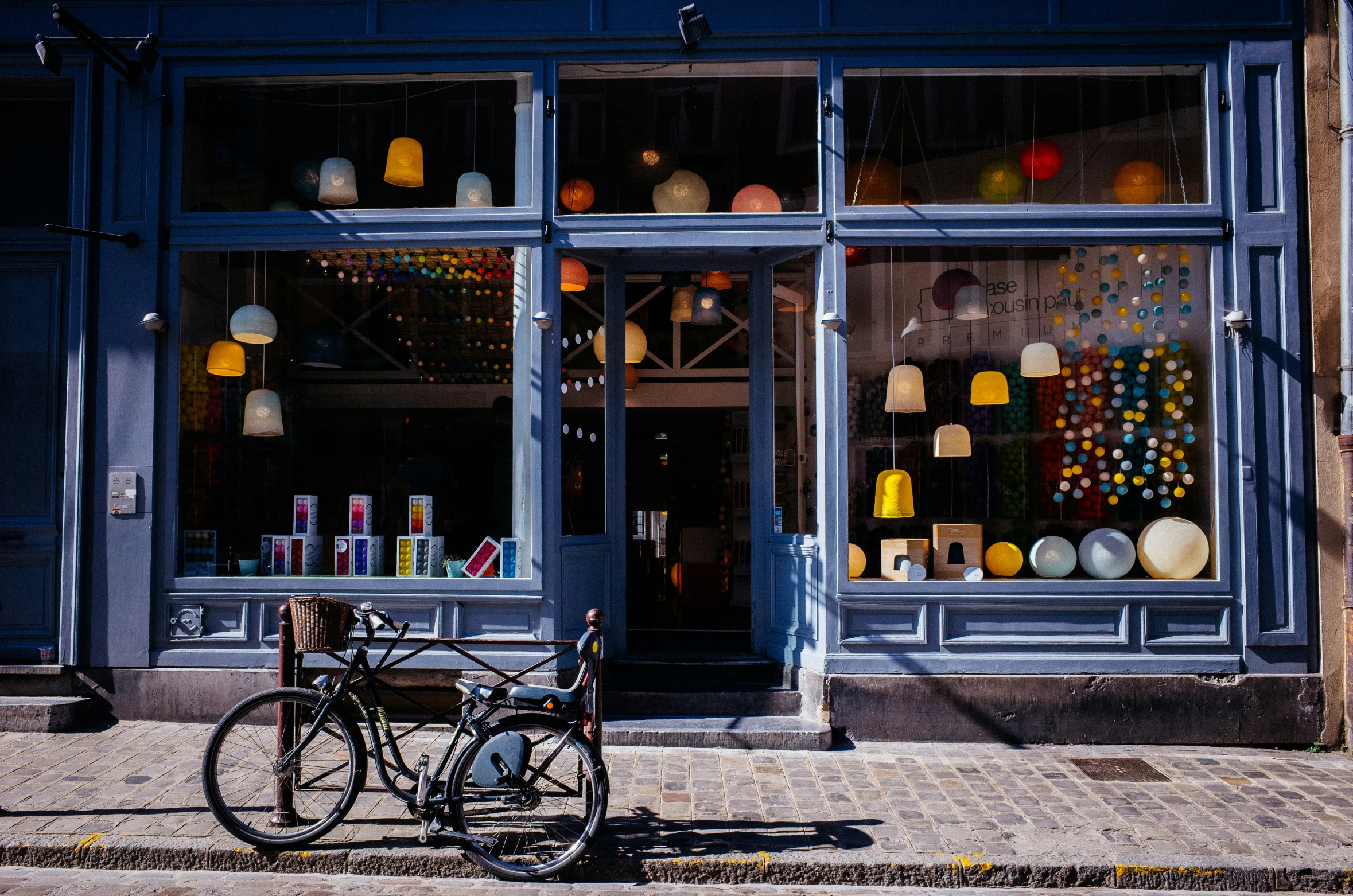 the bike sits parked in front of the window