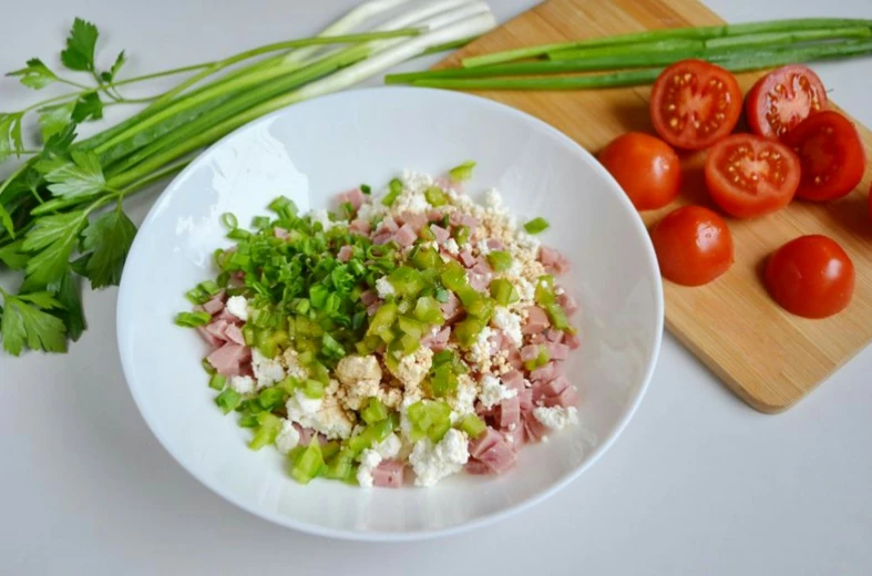 celery, meat, and other vegetables sit on a white plate