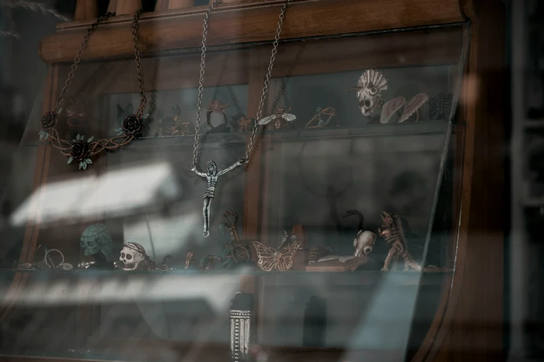 glass display of a skeleton figure, candles and other items