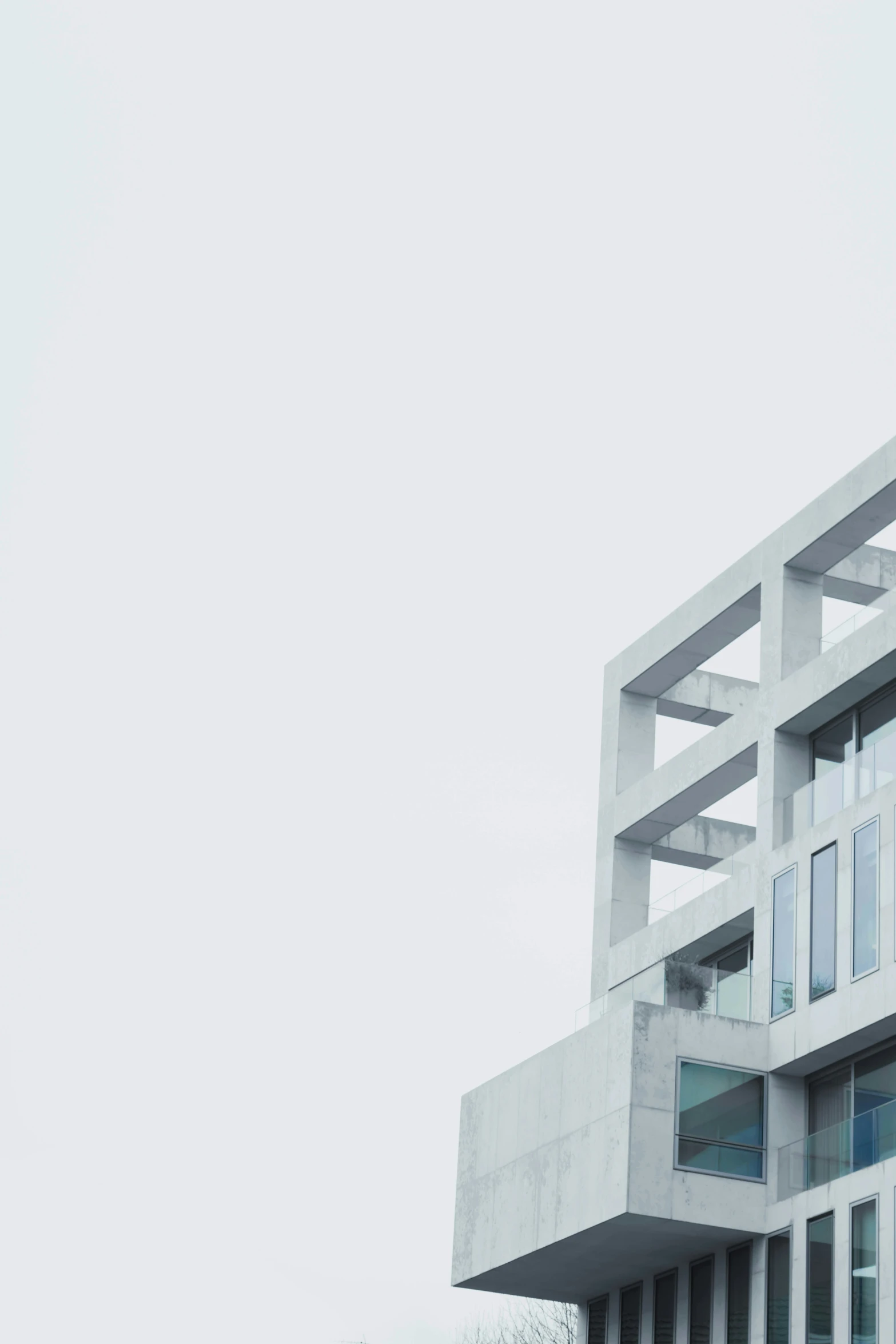 an airplane flying over a tall gray building