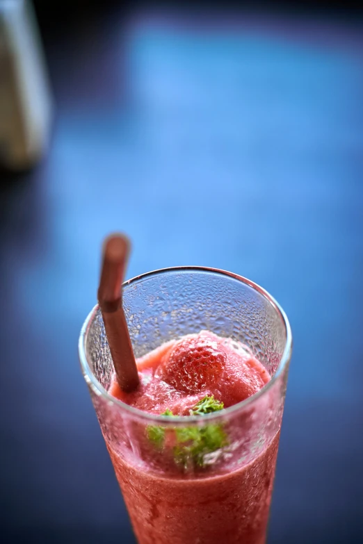 a glass with some liquid inside of it on a table