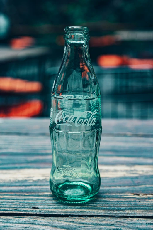 a glass bottle sitting on top of a wooden surface