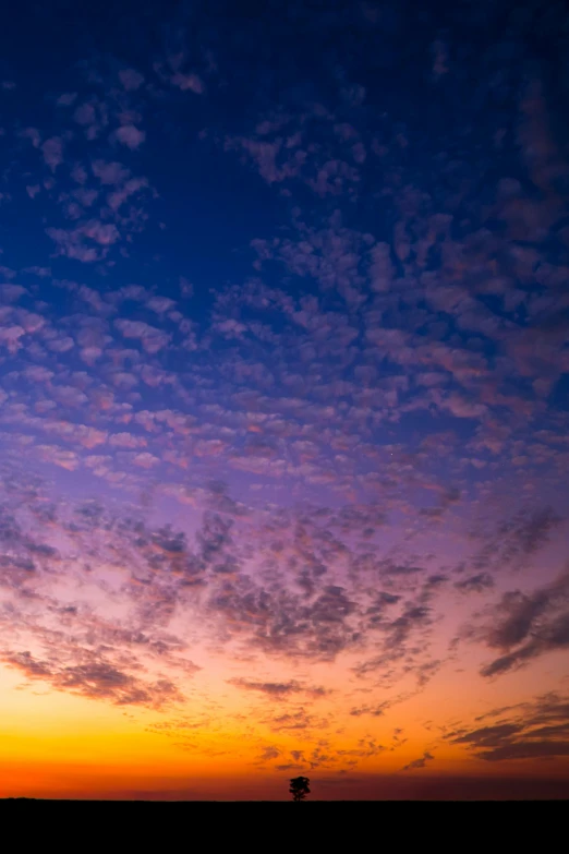 some white clouds some blue and orange lights