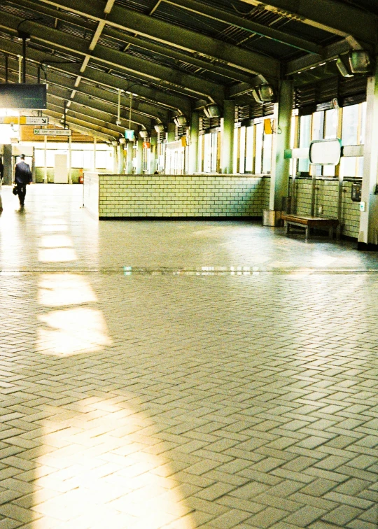 the view from the train platform shows an area with brick floors