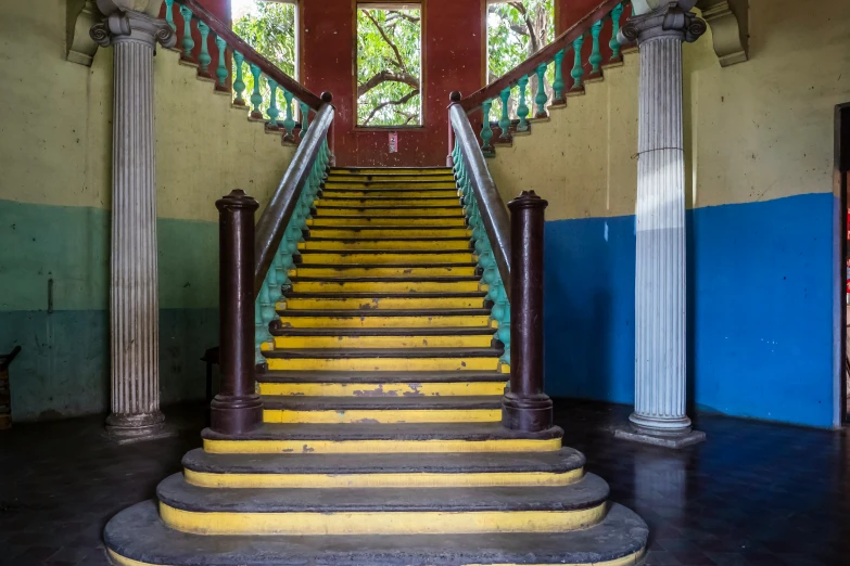 a stairway leading up to an open area with columns