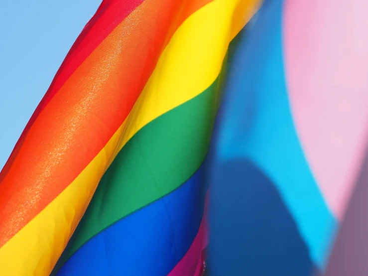 a closeup s of a colorful rainbow colored kite