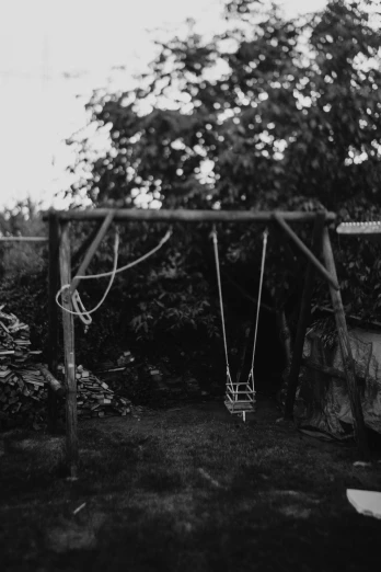 black and white pograph of an outdoor swing set