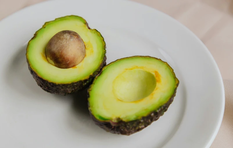 the two halves of an avocado are shown on the plate